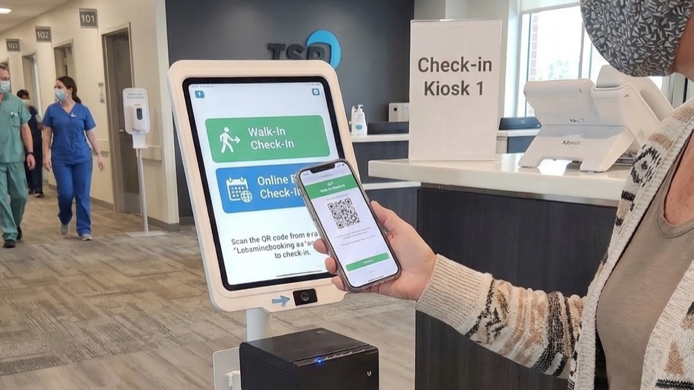 A patient checks in at a self-service kiosk at a public health clinic
